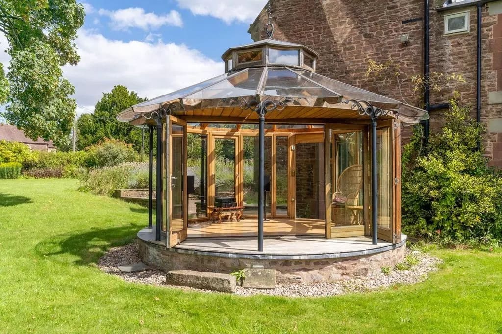 a potential wooden plum village tea house at abenhall with large glass windows