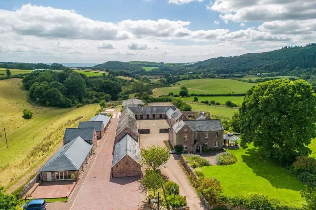aerial of the abenhall estate showing all the brick buildings and a view of the land